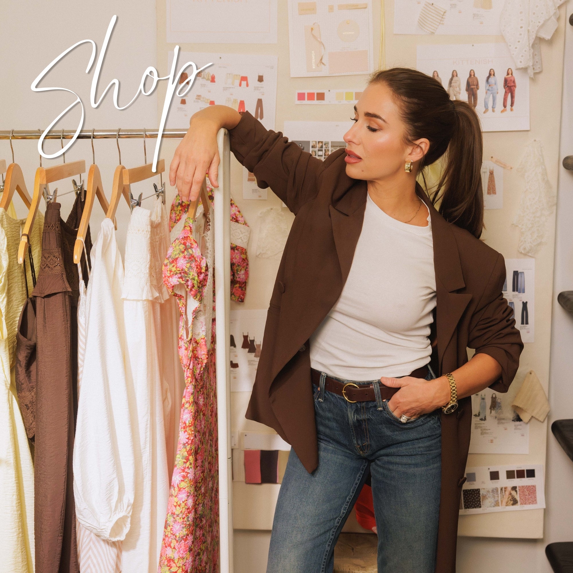 Jessie with a rack of Kittenish clothing and designs with the words "Shop" displayed