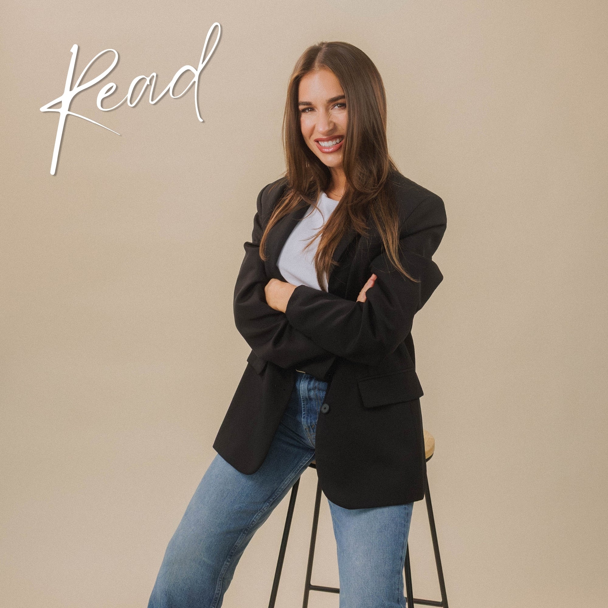 Jessie wearing a black blazer and blue jeans on a beige background with the brand name 'Read' displayed.