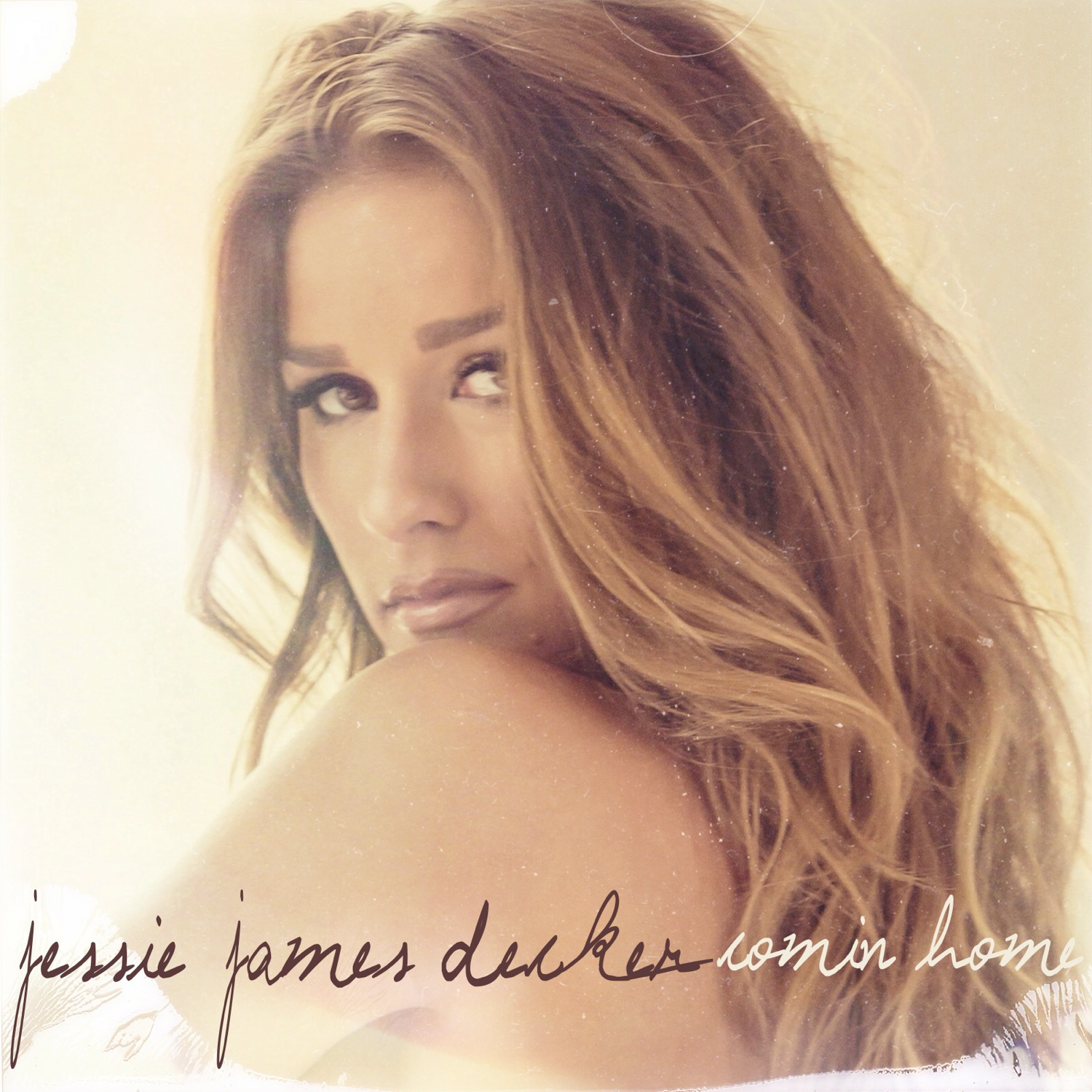 Album cover for Jessie James Decker's 'Comin' Home' featuring a close-up portrait of the artist with wavy light brown hair against a warm cream background, with the album title and artist name in script at the bottom.
