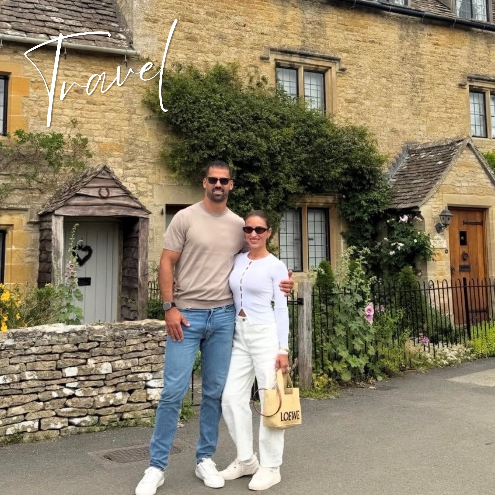 Jessie + Eric standing in front of a quaint stone building with 'Travel' text overlay.